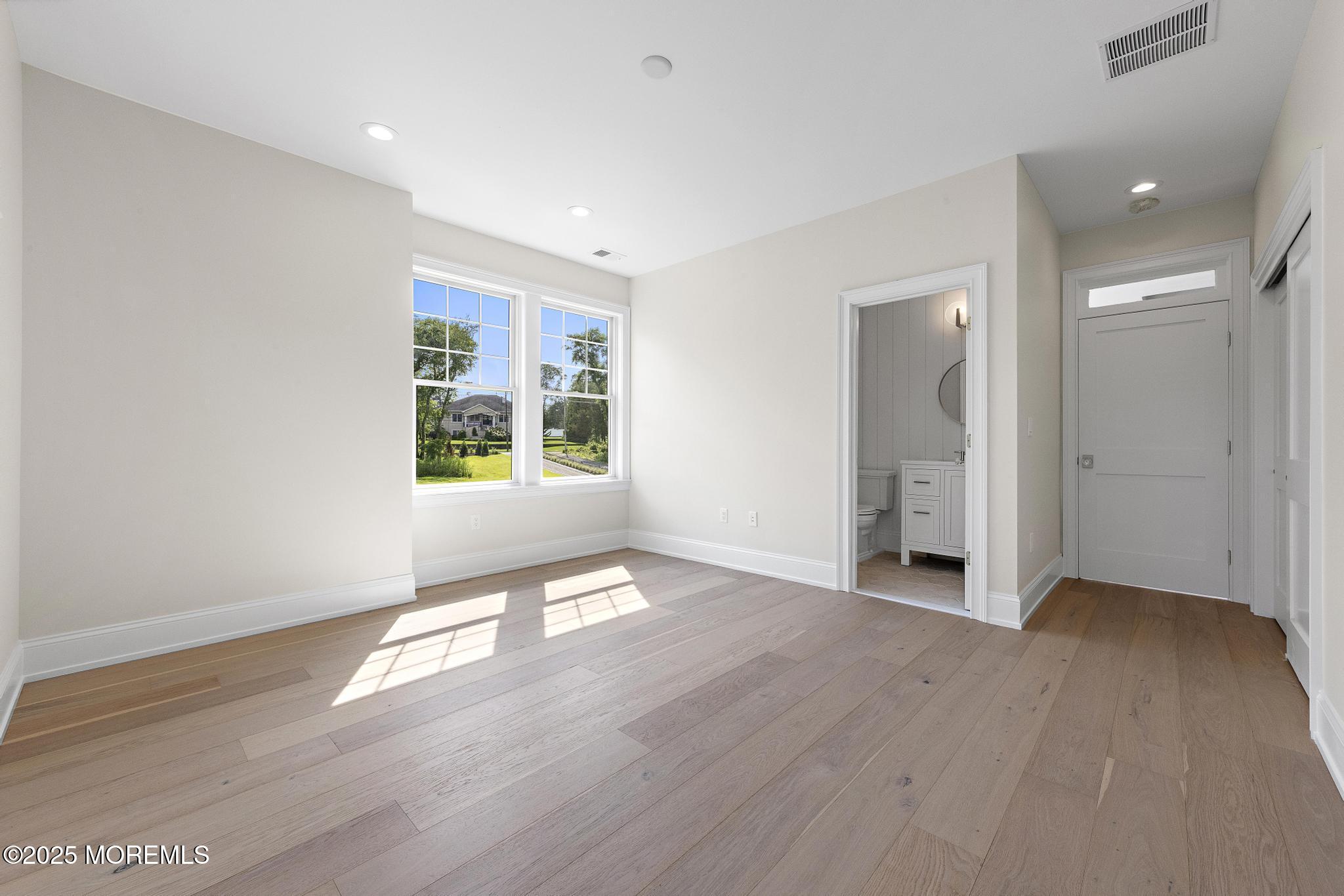1604 Marconi Road Wall, NJ 07719 - Photo 49 of 69 an empty room with wooden floor and windows