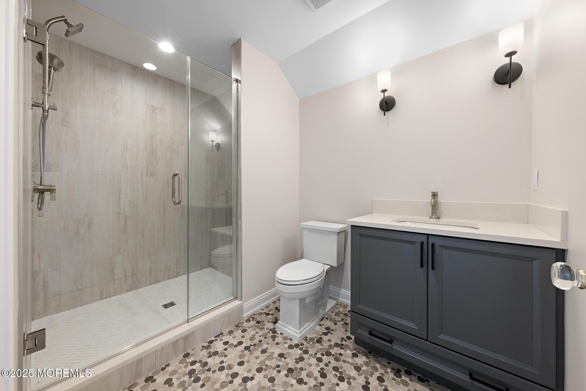 1604 Marconi Road Wall, NJ 07719 - Photo 58 of 69 a bathroom with a shower sink vanity and toilet