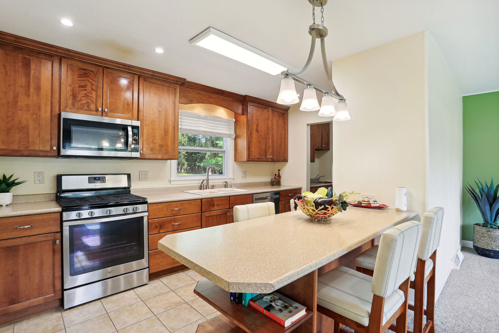 1111 Theodore Drive Champaign, IL 61821 - Photo 13 of 34 a kitchen with a stove a sink a microwave a dining table and chairs