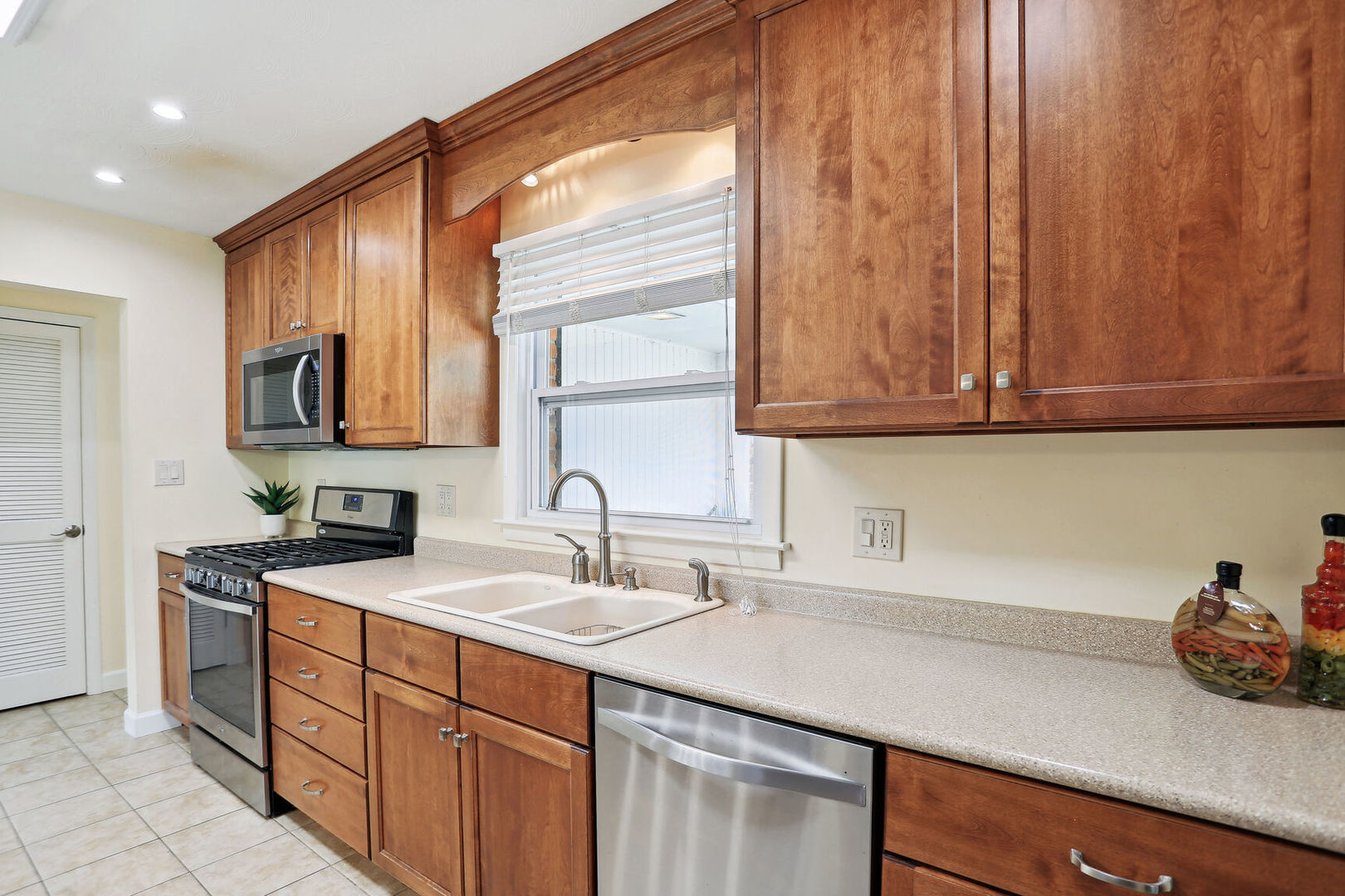 1111 Theodore Drive Champaign, IL 61821 - Photo 14 of 34 a kitchen with a sink cabinets and stainless steel appliances