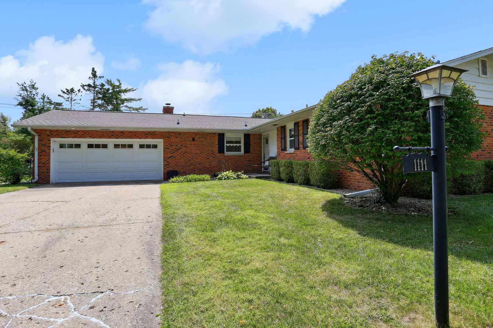 1111 Theodore Drive Champaign, IL 61821 - Photo 2 of 34 a front view of a house with garden