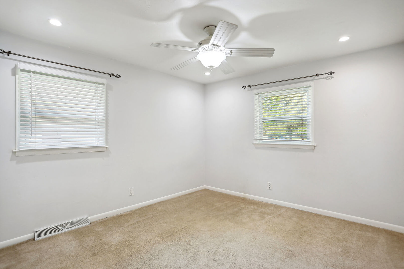 1111 Theodore Drive Champaign, IL 61821 - Photo 23 of 34 en empty room with windows and chandelier fan