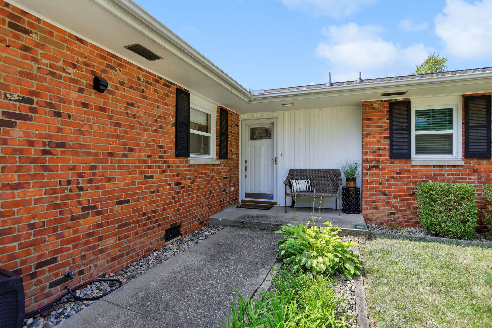 1111 Theodore Drive Champaign, IL 61821 - Photo 4 of 34 a brick house with potted plants in front of it