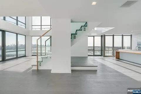 a view of an entryway with a floor to ceiling window and an empty room