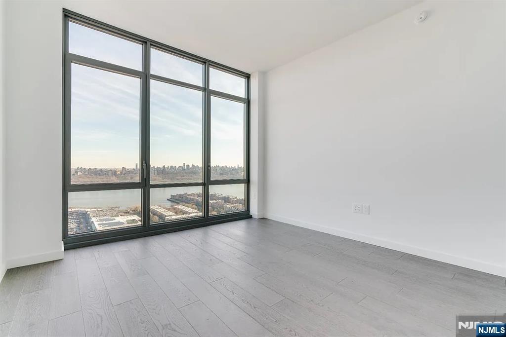320 Adolphus Avenue, Unit 1415 Cliffside Park, NJ 07010 - Photo 11 of 35 an empty room with sliding glass door
