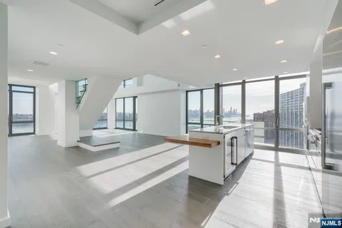 a large white room with a large window and furniture