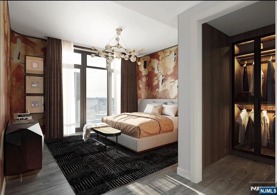 320 Adolphus Avenue, Unit 1415 Cliffside Park, NJ 07010 - Photo 15 of 35 a bedroom with a large bed and a chandelier