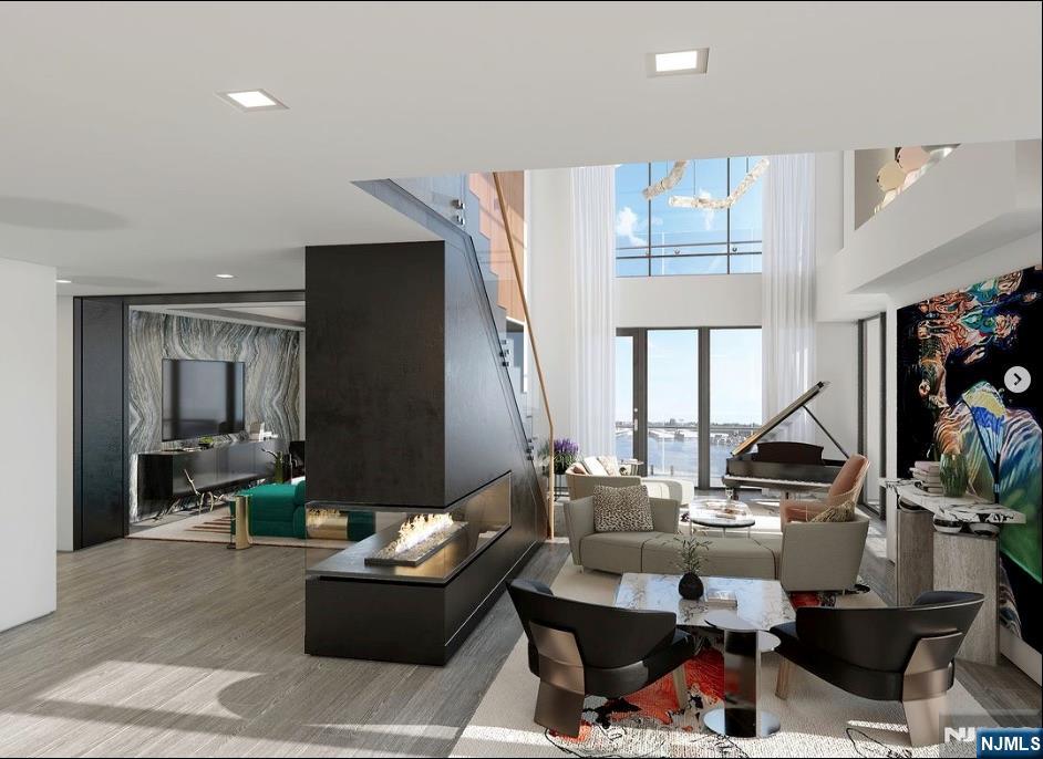 320 Adolphus Avenue, Unit 1415 Cliffside Park, NJ 07010 - Photo 16 of 35 a living room with furniture and a flat screen tv