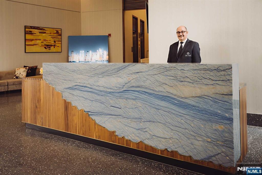 320 Adolphus Avenue, Unit 1415 Cliffside Park, NJ 07010 - Photo 17 of 35 a bed sitting in a bedroom and a mirror