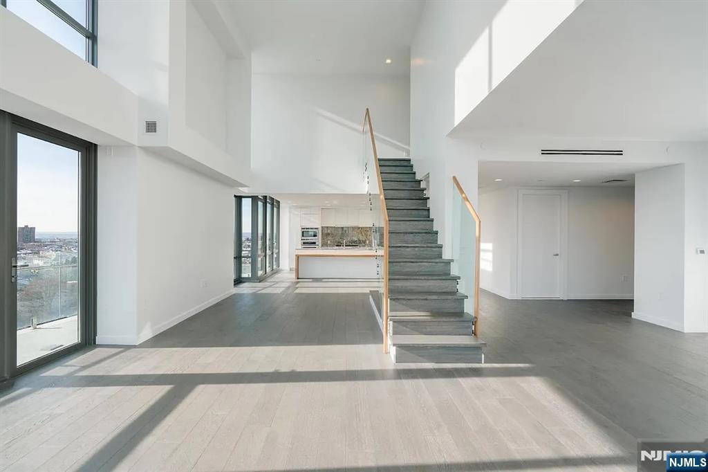 320 Adolphus Avenue, Unit 1415 Cliffside Park, NJ 07010 - Photo 8 of 35 a view of staircase with white walls and windows