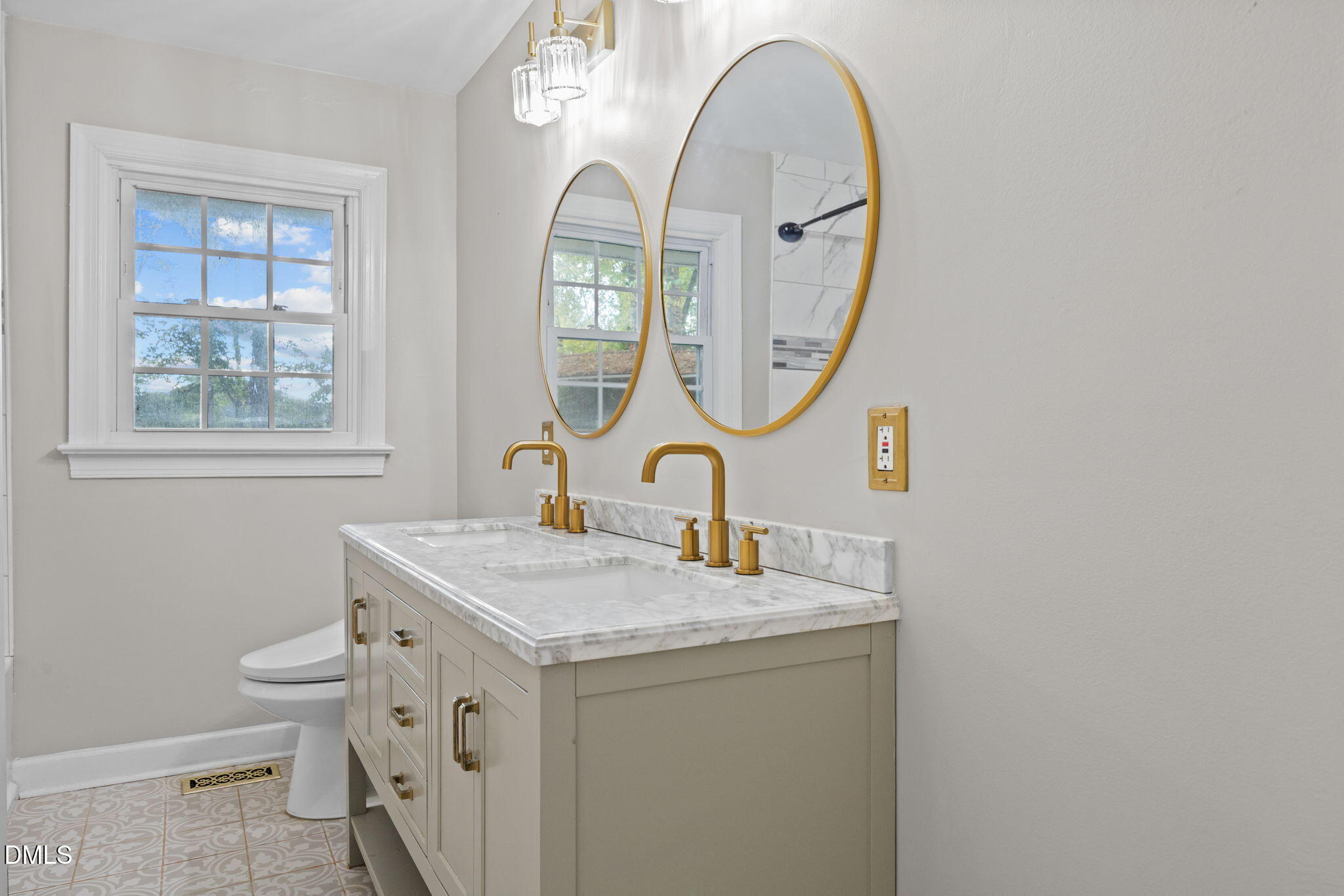 2950 Glenridge Drive Raleigh, NC 27604 - Photo 30 of 53 a bathroom with a granite countertop toilet a sink and a mirror