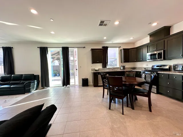a view of a livingroom with furniture and a stove