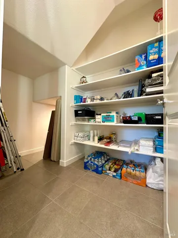 a view of a hallway with wooden shelves