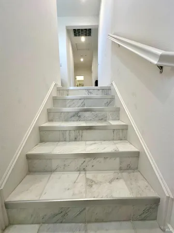 a bedroom with a bed and a large mirror