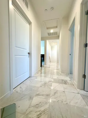 a living room with furniture and a piano