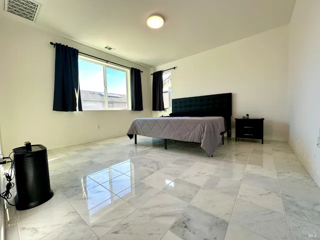 a bedroom with a bed and a mirror