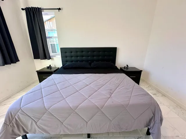 a view of a bedroom with a bed and closet