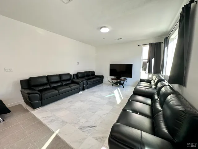 a kitchen with kitchen island a dining table and chairs
