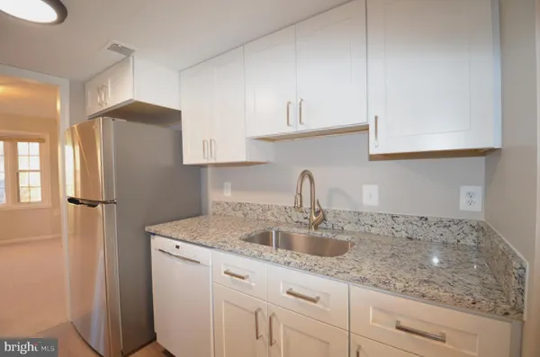 a kitchen with sink cabinets and window