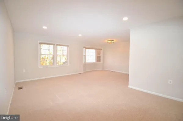 an empty room with windows and closet