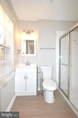 a bathroom with a toilet sink and a mirror