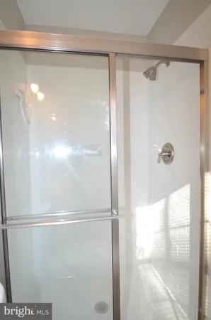a bathroom with a glass shower door