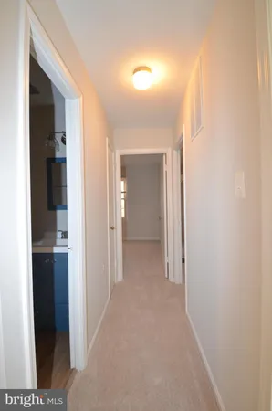 a view of hallway with bathroom