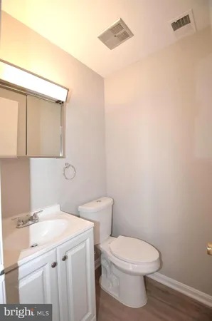 a bathroom with a sink a toilet and mirror