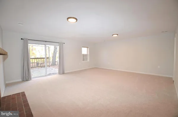 a view of empty room with a fireplace