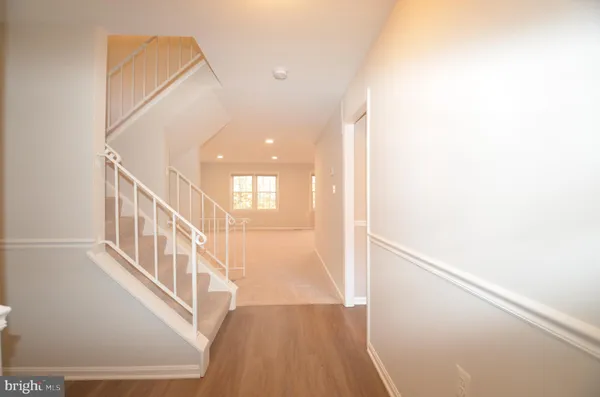 a view of an entryway with wooden floor