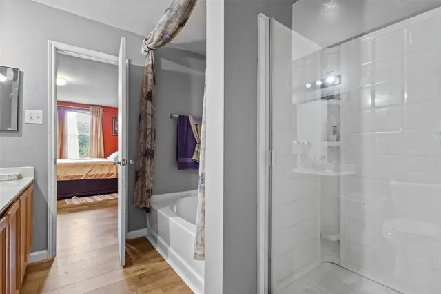 a bathroom with a tub and shower