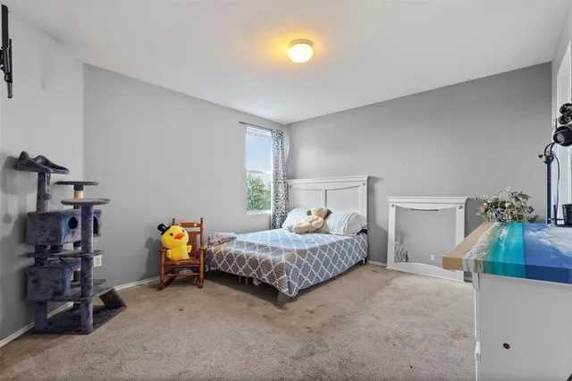 a bedroom with bed and a couch