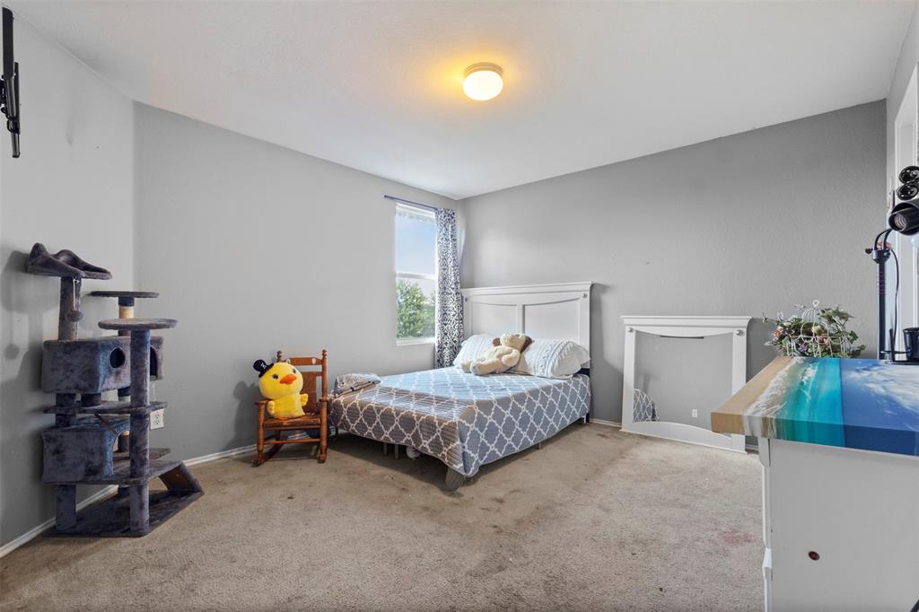 1034 Hollow Oak Road Lancaster, TX 75134 - Photo 21 of 29 a bedroom with bed and a couch