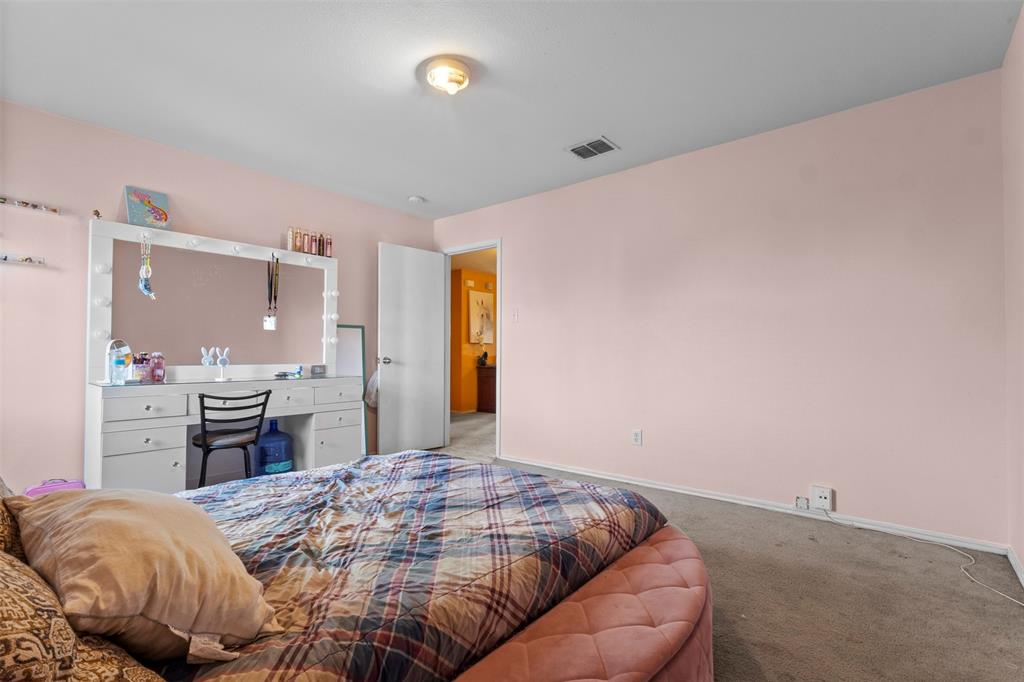 1034 Hollow Oak Road Lancaster, TX 75134 - Photo 22 of 29 a bedroom with a bed and cabinets
