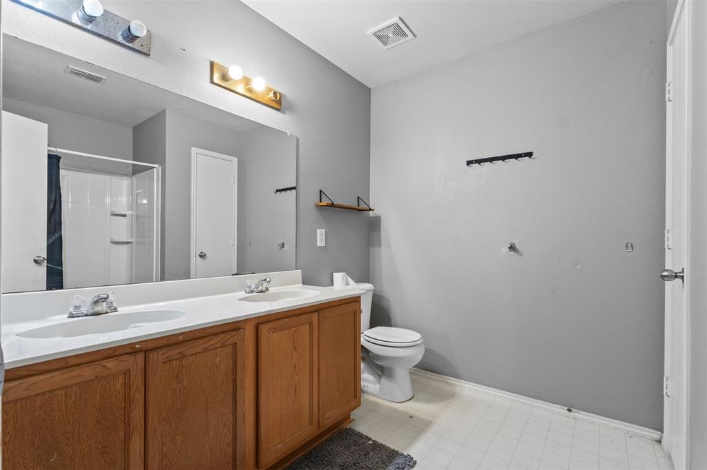 1034 Hollow Oak Road Lancaster, TX 75134 - Photo 23 of 29 a bathroom with a sink and a mirror