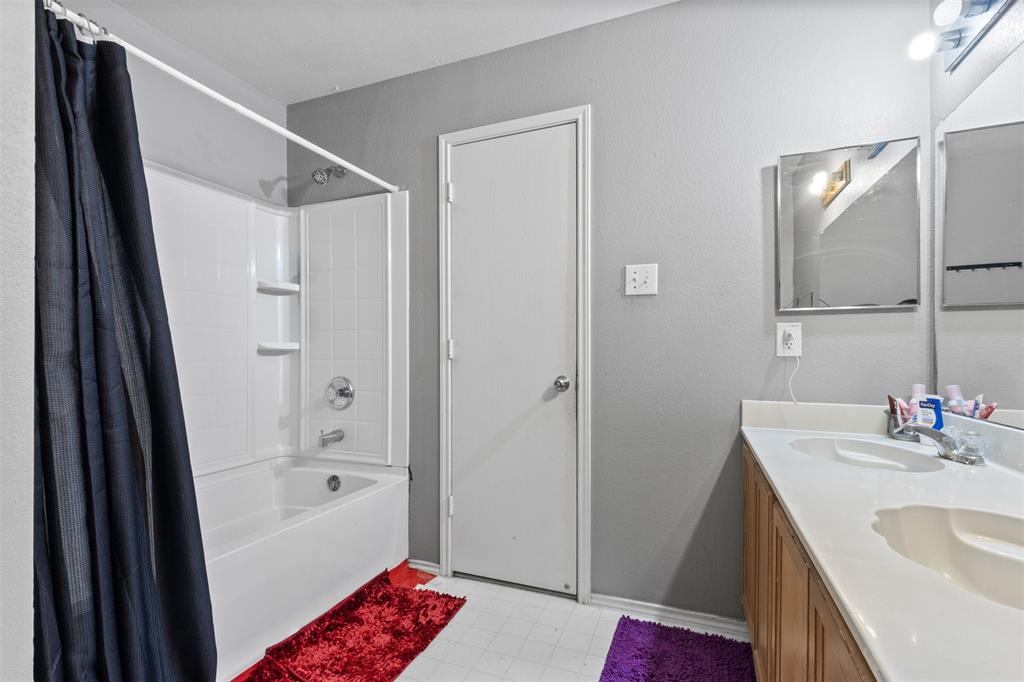 1034 Hollow Oak Road Lancaster, TX 75134 - Photo 24 of 29 a bathroom with a tub sink and mirror