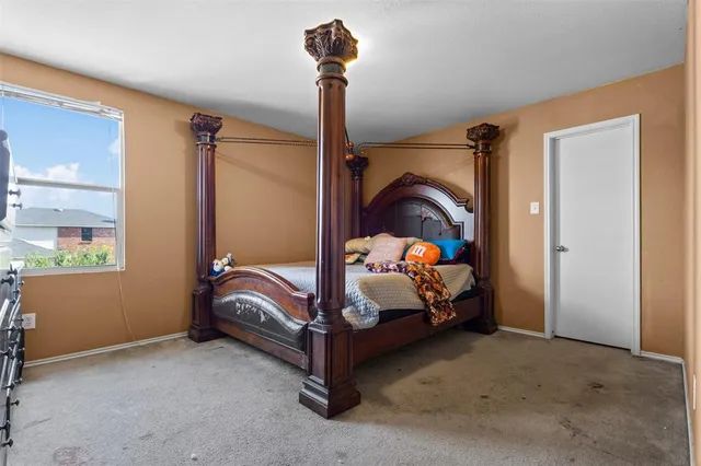 a bedroom with a bed and a window