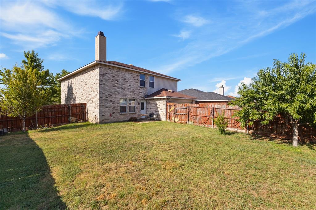 1034 Hollow Oak Road Lancaster, TX 75134 - Photo 29 of 29 a front view of a house with a garden and yard