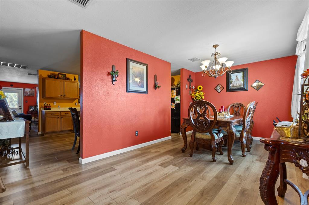 1034 Hollow Oak Road Lancaster, TX 75134 - Photo 4 of 29 a view of a dining room with furniture and wooden floor