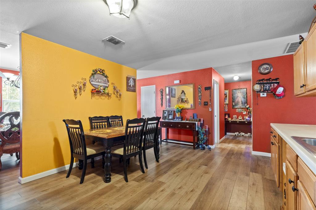1034 Hollow Oak Road Lancaster, TX 75134 - Photo 7 of 29 a view of a dining room with furniture and wooden floor