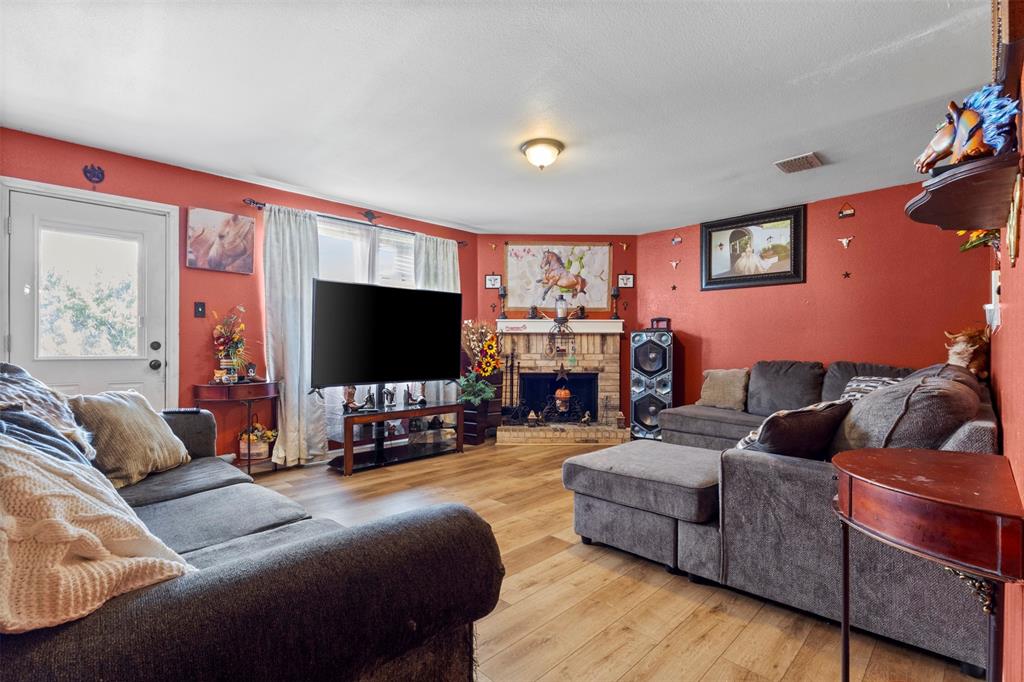1034 Hollow Oak Road Lancaster, TX 75134 - Photo 9 of 29 a living room with furniture and a flat screen tv