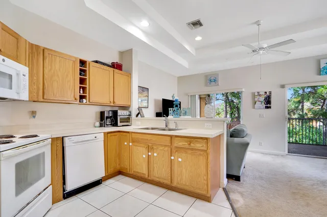 a kitchen with a sink window and cabinets