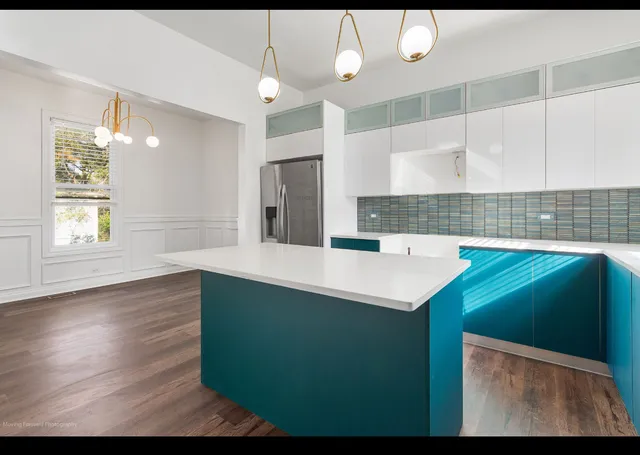a kitchen with green cabinets a sink and dishwasher
