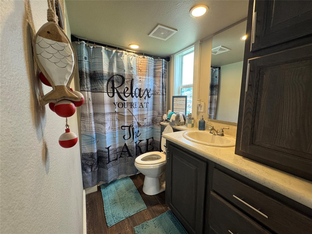 5000 Waterfront Road, Unit 126 Kerens, TX 75144 - Photo 26 of 28 a bathroom with a sink toilet and shower