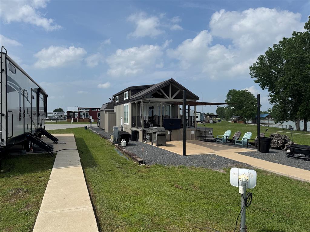 5000 Waterfront Road, Unit 126 Kerens, TX 75144 - Photo 27 of 28 a view of a house with a yard patio and fire pit