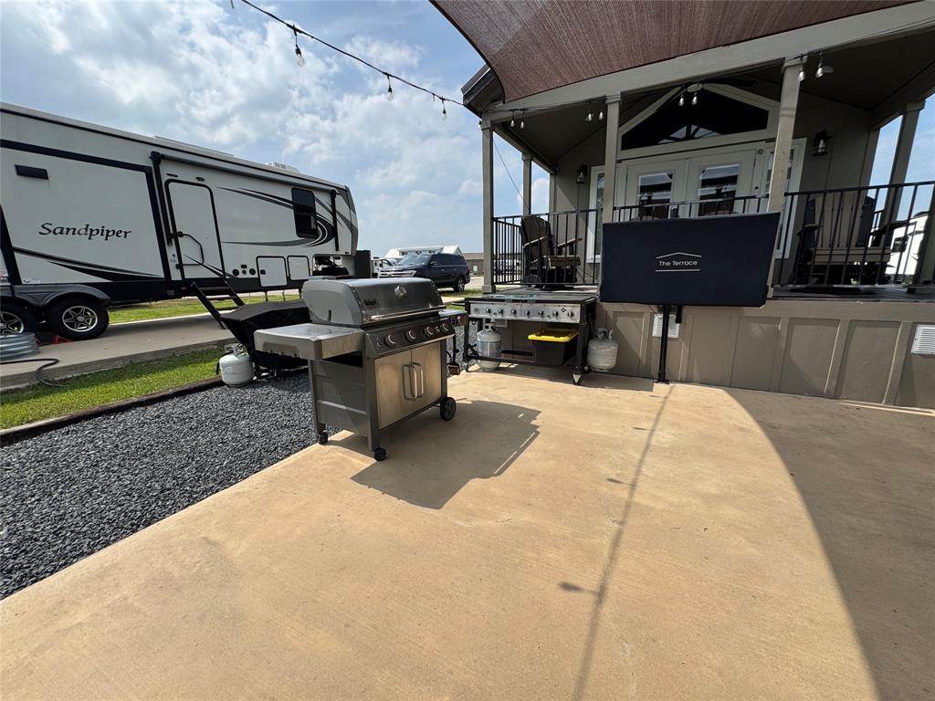 5000 Waterfront Road, Unit 126 Kerens, TX 75144 - Photo 8 of 28 a view of a patio with table and chairs with wooden floor