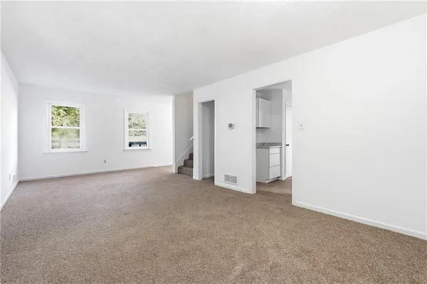 an empty room with windows and closet