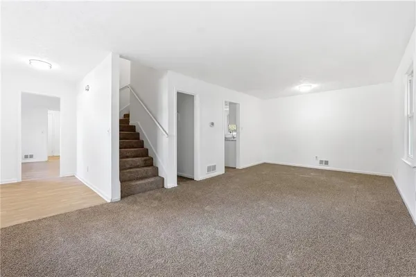 a view of a room with stairs and a bathroom