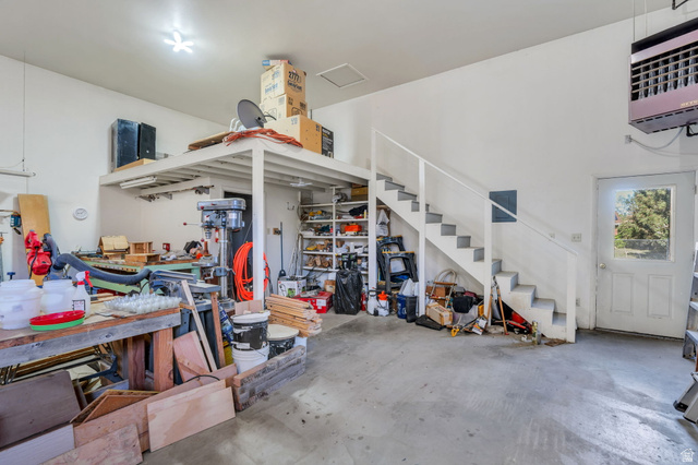 377 North 650 East, Unit 9 Orem, UT 84097 - Photo 9 of 9 Spacious utility area featuring a concrete floor, white painted walls, and an overhead storage loft