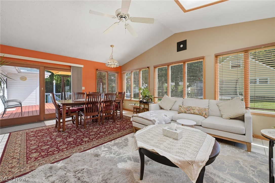 1499 Morris Road Kent, OH 44240 - Photo 19 of 41 Vaulted ceiling sunroom featuring multiple large windows, a skylight, and direct access to an outdoor deck